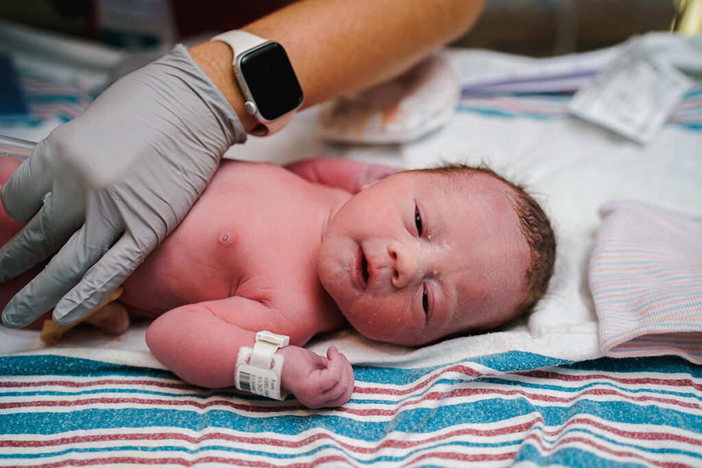 A new baby gets her exam at Mercy's Love Family Women's Center.